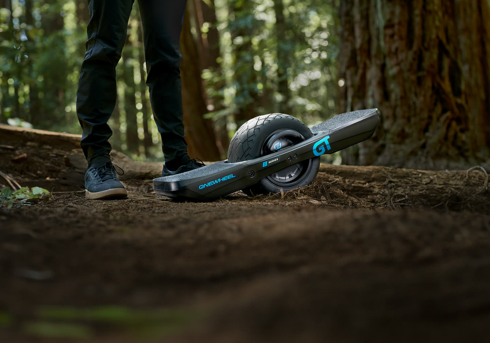 Rider on a Onewheel GT on a forest trail