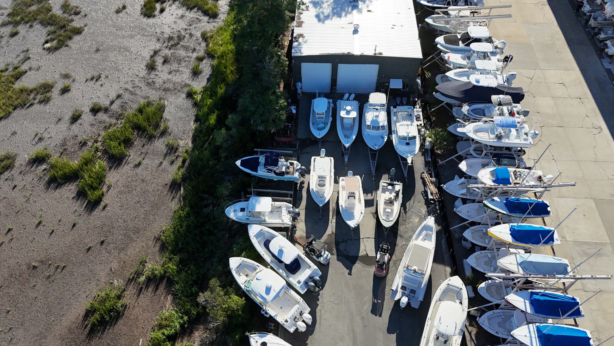 Aerial view of the Dolan Yacht Services shop and boat yard beside the marsh at Landings Harbor Marina